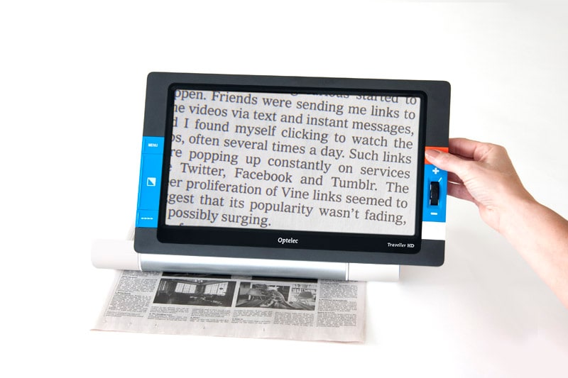 large portable electronic magnifier placed over magazine